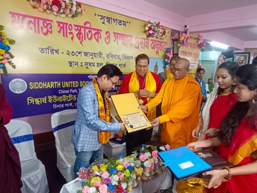 Dr. Dhires Chowdhury reciving Award from Dr. Bhuddhapriyo Mahathero