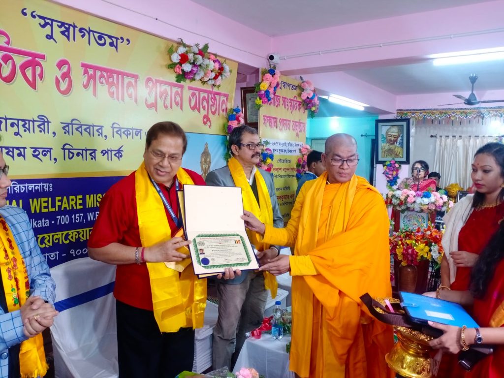 Dr. Naba Kumar Basu receiving award from  Monk General Secretary Dr. Bhuddhapriyo Mahathero